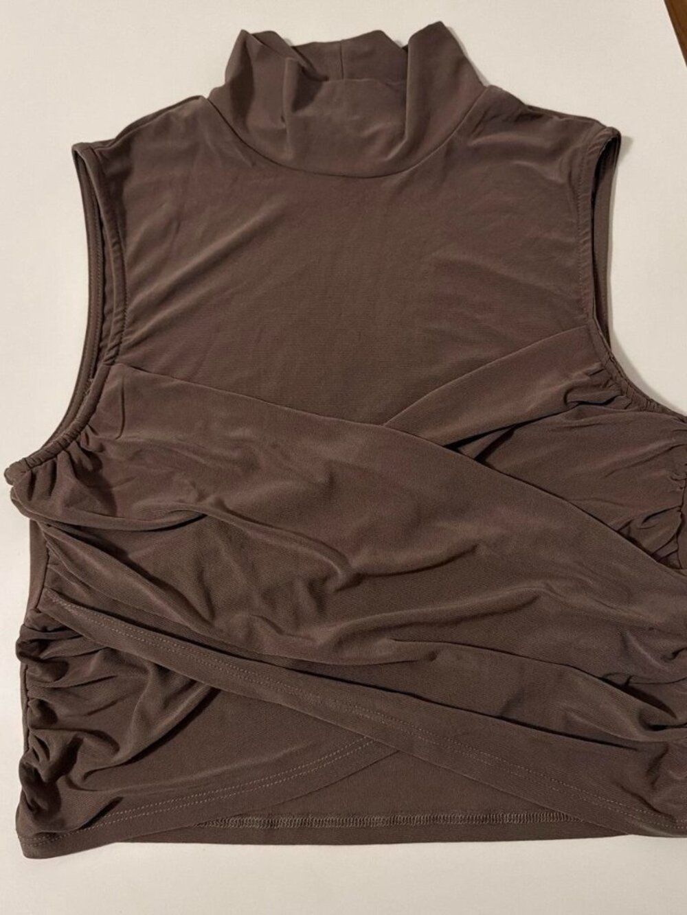 Brown sleeveless crop top with a high neck and criss-cross detail